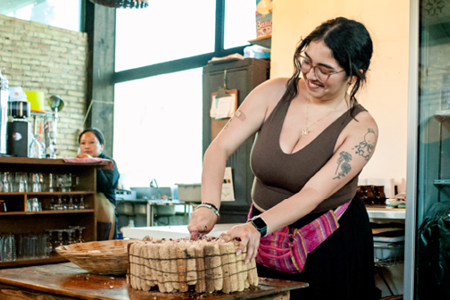 Student participating in a traditional food preparation activity during the C M A S study abroad program in Mexico